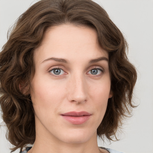 Joyful white young-adult female with medium  brown hair and green eyes