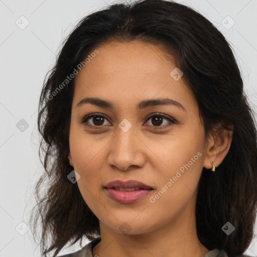 Joyful latino young-adult female with long  brown hair and brown eyes