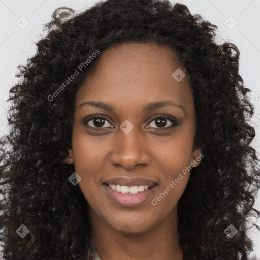 Joyful black young-adult female with long  brown hair and brown eyes