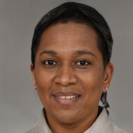 Joyful black adult female with short  brown hair and brown eyes