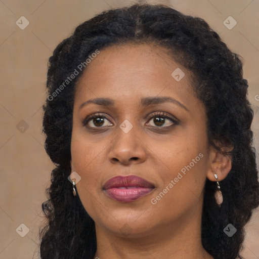 Joyful black young-adult female with long  brown hair and brown eyes