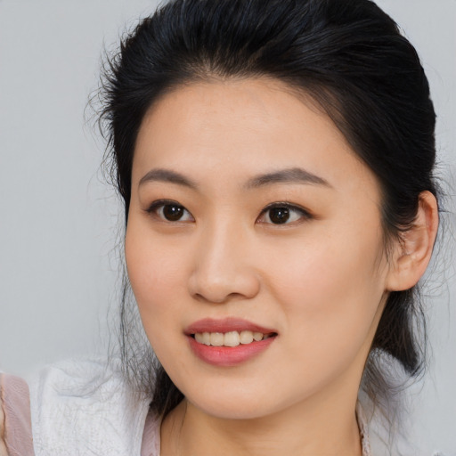 Joyful asian young-adult female with medium  brown hair and brown eyes