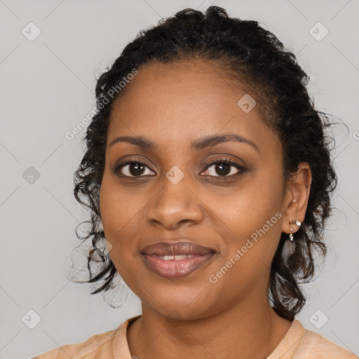 Joyful black young-adult female with medium  black hair and brown eyes