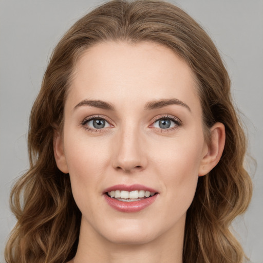 Joyful white young-adult female with long  brown hair and grey eyes