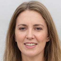 Joyful white young-adult female with long  brown hair and grey eyes