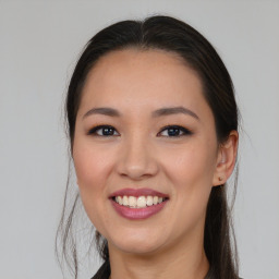 Joyful asian young-adult female with medium  brown hair and brown eyes