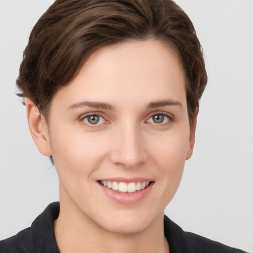 Joyful white young-adult female with short  brown hair and grey eyes