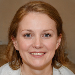 Joyful white young-adult female with medium  brown hair and blue eyes