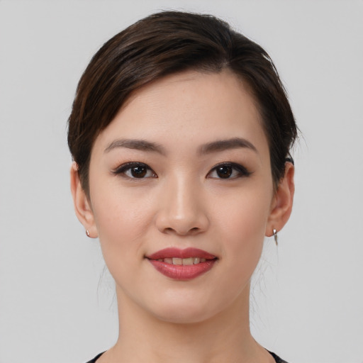 Joyful white young-adult female with medium  brown hair and brown eyes