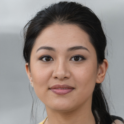 Joyful asian young-adult female with medium  brown hair and brown eyes