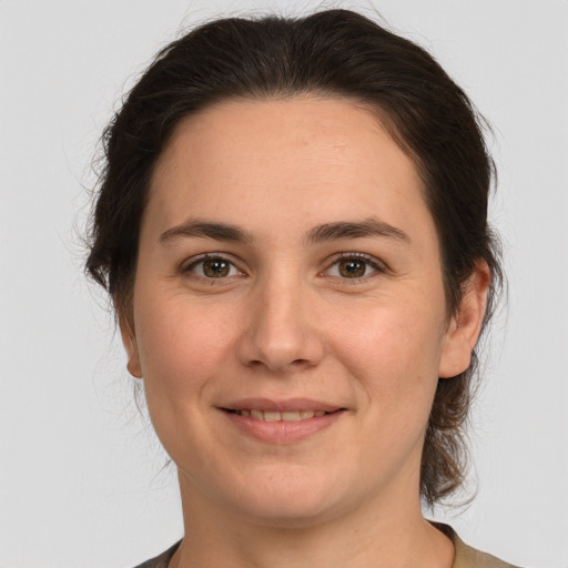 Joyful white young-adult female with medium  brown hair and brown eyes