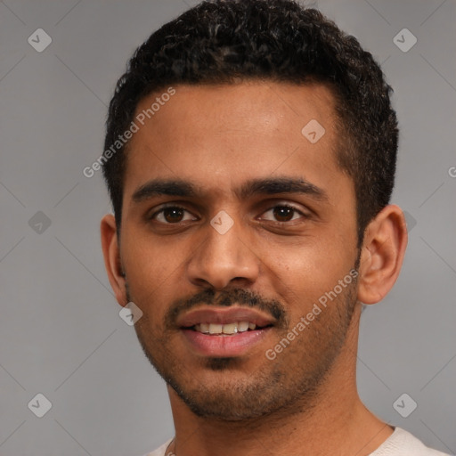 Joyful black young-adult male with short  black hair and brown eyes