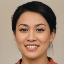 Joyful asian young-adult female with medium  brown hair and brown eyes