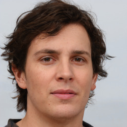 Joyful white young-adult male with medium  brown hair and brown eyes