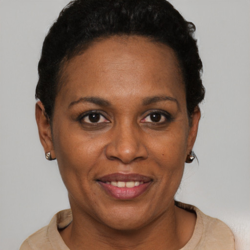 Joyful black adult female with short  brown hair and brown eyes