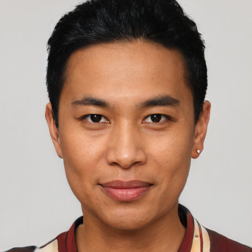 Joyful asian young-adult male with short  black hair and brown eyes