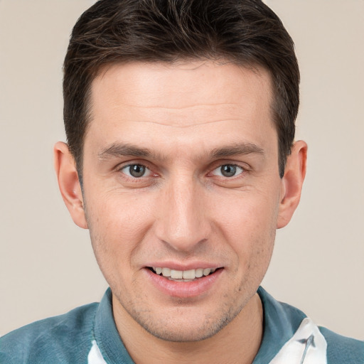 Joyful white adult male with short  brown hair and brown eyes