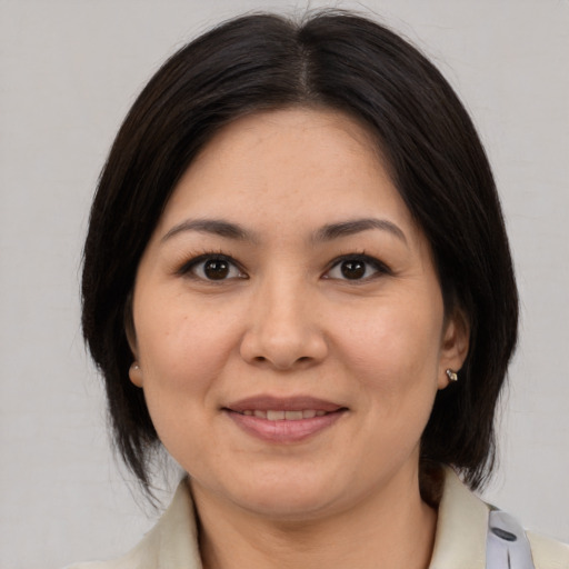 Joyful latino adult female with medium  brown hair and brown eyes