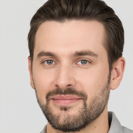 Joyful white adult male with short  brown hair and brown eyes