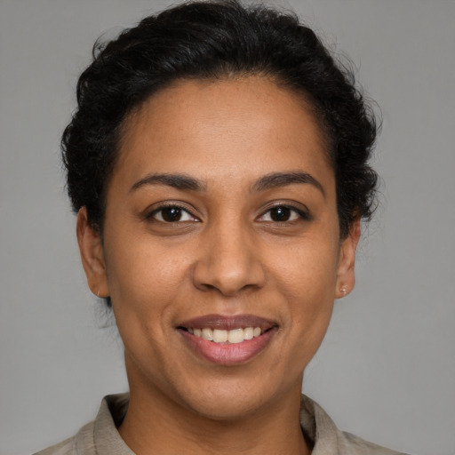 Joyful latino young-adult female with short  brown hair and brown eyes