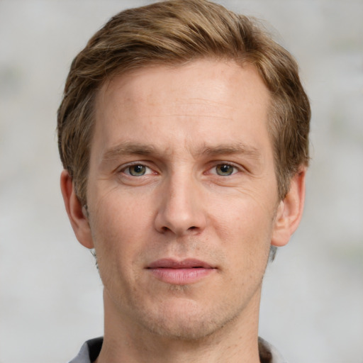 Joyful white adult male with short  brown hair and grey eyes