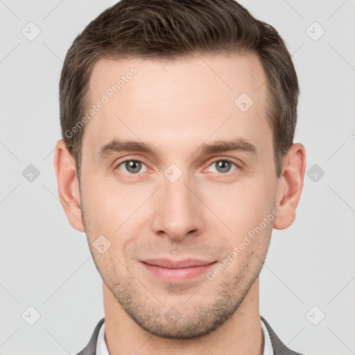 Joyful white young-adult male with short  brown hair and grey eyes