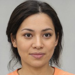 Joyful asian young-adult female with medium  brown hair and brown eyes