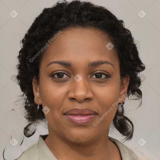 Joyful black adult female with medium  brown hair and brown eyes