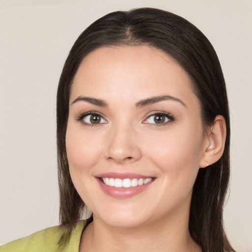 Joyful white young-adult female with long  brown hair and brown eyes