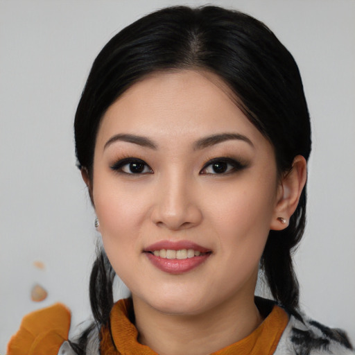 Joyful asian young-adult female with medium  black hair and brown eyes