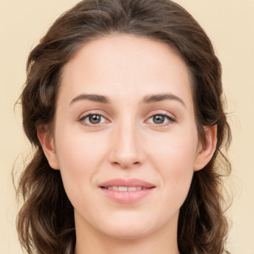 Joyful white young-adult female with long  brown hair and green eyes