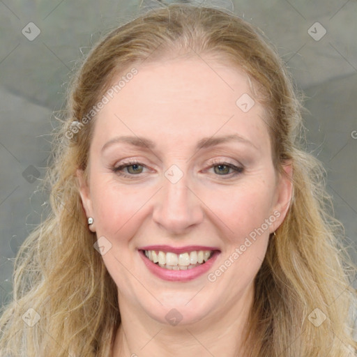 Joyful white young-adult female with medium  brown hair and blue eyes