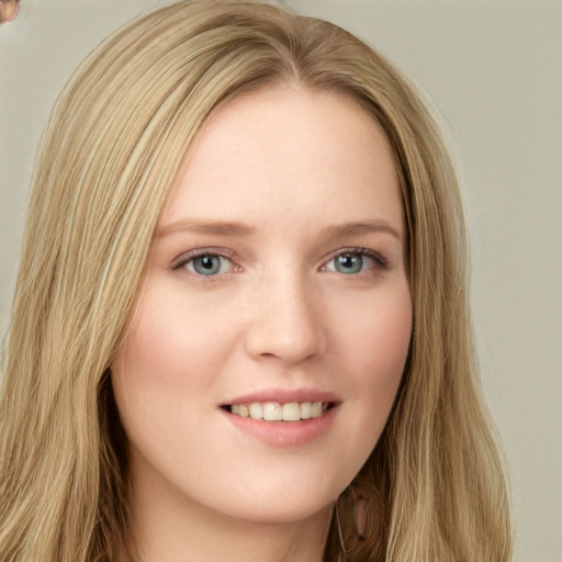 Joyful white young-adult female with long  brown hair and green eyes