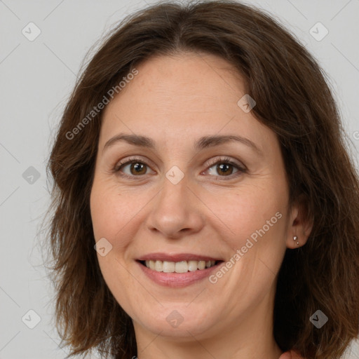 Joyful white adult female with long  brown hair and brown eyes