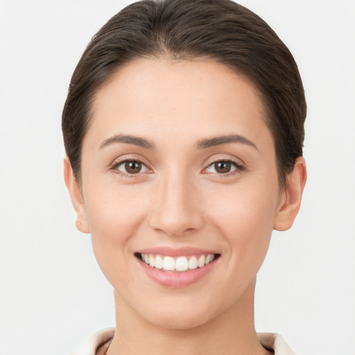 Joyful white young-adult female with short  brown hair and brown eyes