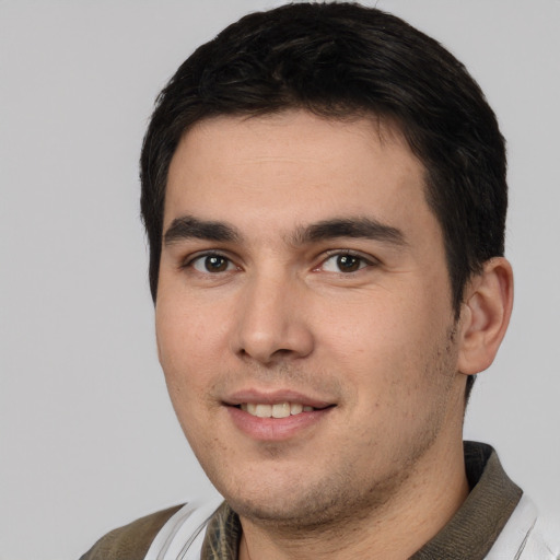 Joyful white young-adult male with short  black hair and brown eyes