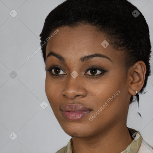 Joyful black young-adult female with short  black hair and brown eyes