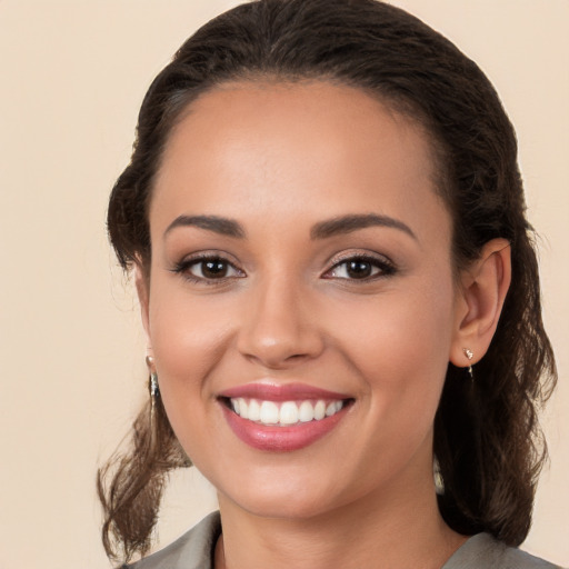 Joyful white young-adult female with long  brown hair and brown eyes