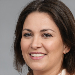 Joyful white adult female with medium  brown hair and brown eyes