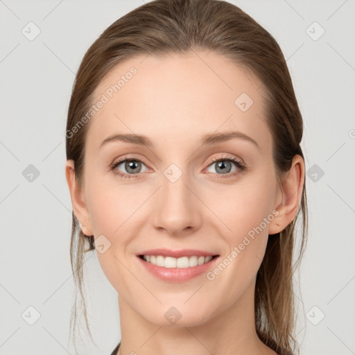 Joyful white young-adult female with medium  brown hair and grey eyes