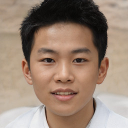 Joyful asian child male with short  brown hair and brown eyes
