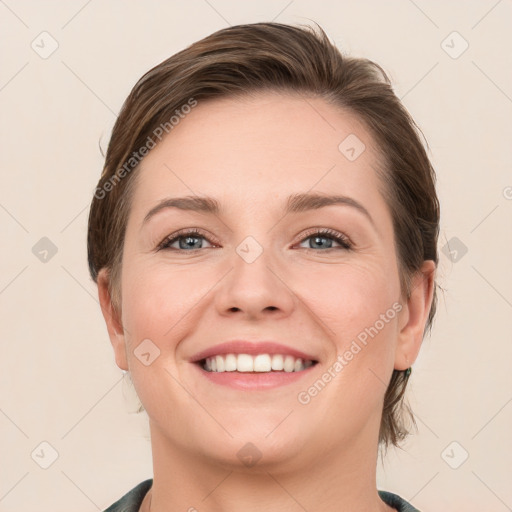 Joyful white young-adult female with medium  brown hair and grey eyes