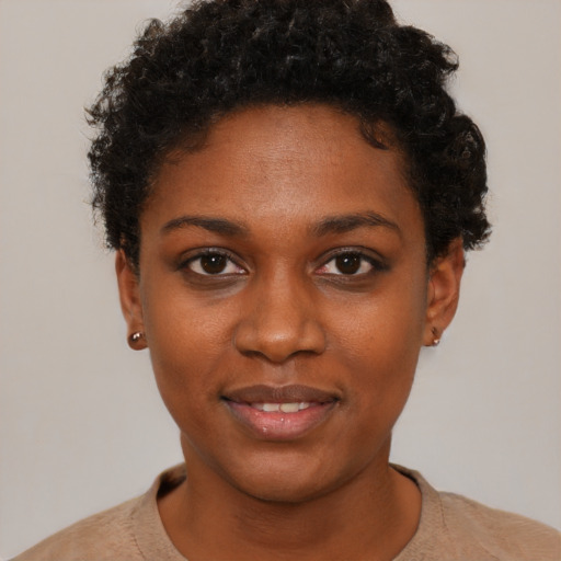 Joyful black young-adult female with short  brown hair and brown eyes