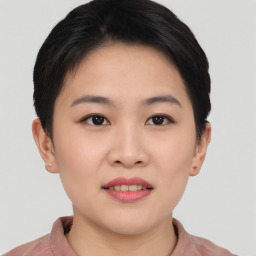 Joyful asian young-adult female with short  black hair and brown eyes