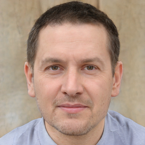 Joyful white adult male with short  brown hair and brown eyes