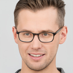 Joyful white adult male with short  brown hair and grey eyes