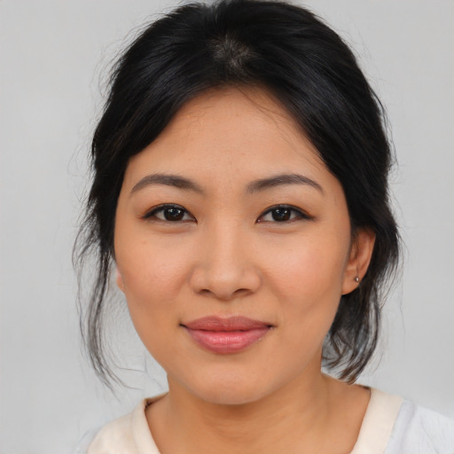 Joyful asian young-adult female with medium  brown hair and brown eyes