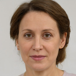 Joyful white adult female with medium  brown hair and green eyes