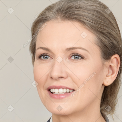 Joyful white adult female with medium  brown hair and grey eyes