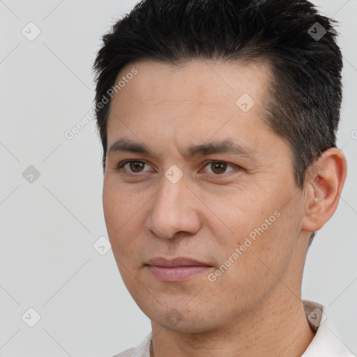 Joyful white adult male with short  black hair and brown eyes